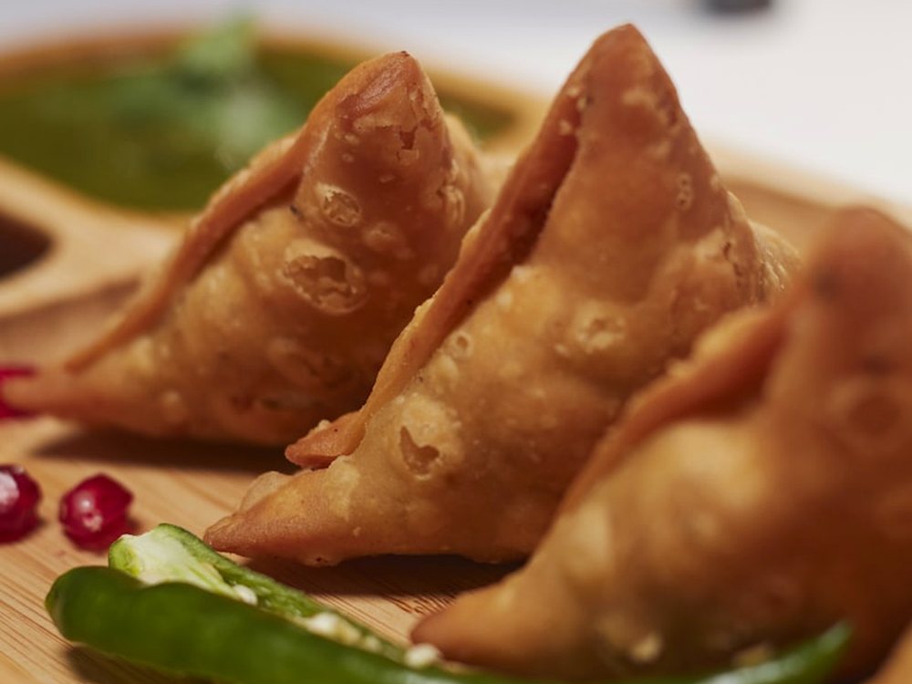 Samosas, folded and fried to order